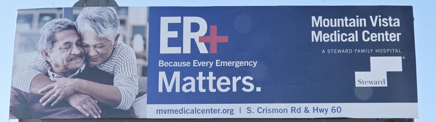 A billboard for Mountain Vista Medical Center. An older couple embraces beside the words ER, Because Every Emergency Matters.